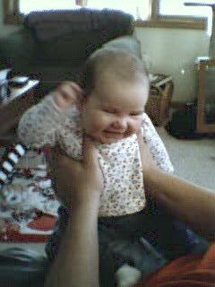 sitting up, laughing