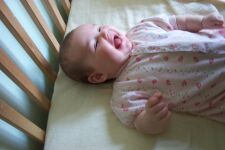 Smiling in her crib