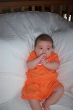 pensive in an orange outfit.