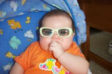 sunglasses in her bouncy chair